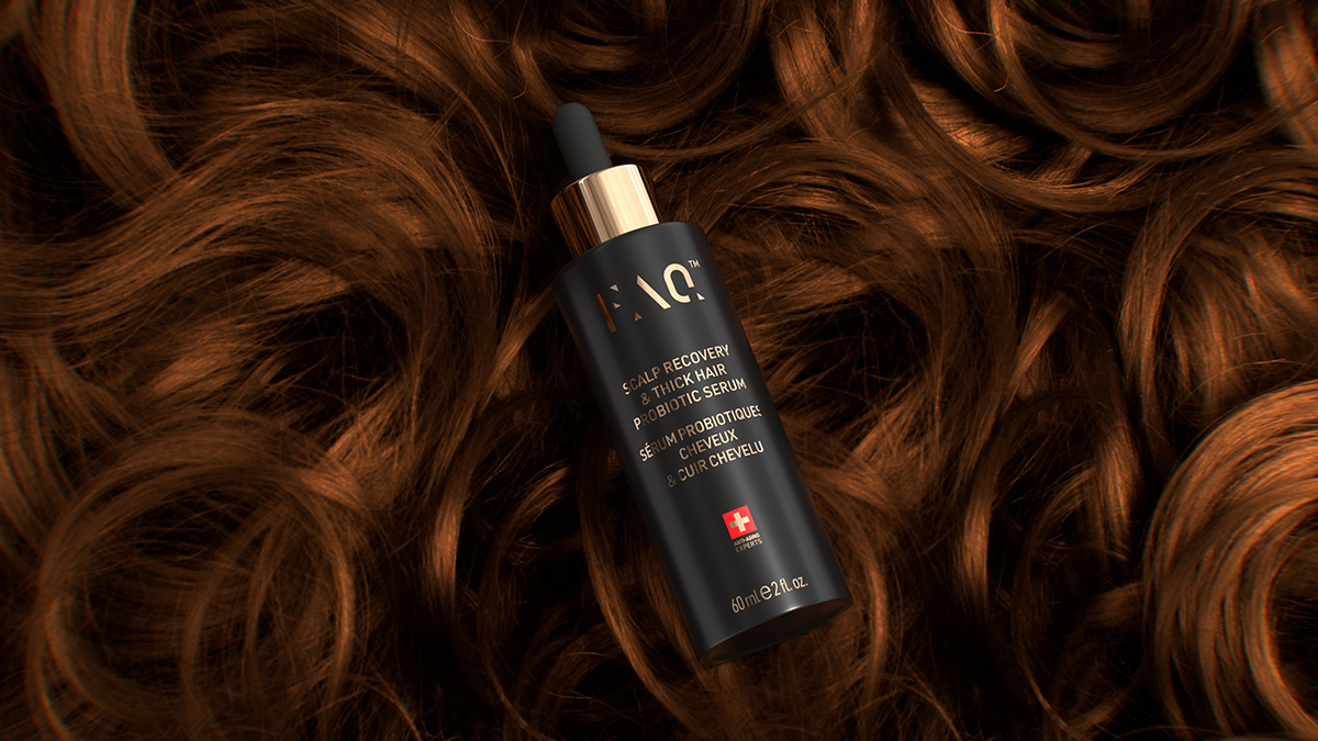 FAQ Scalp Recovery & Thick Hair Probiotic Serum lying flat on ringlets of auburn hair